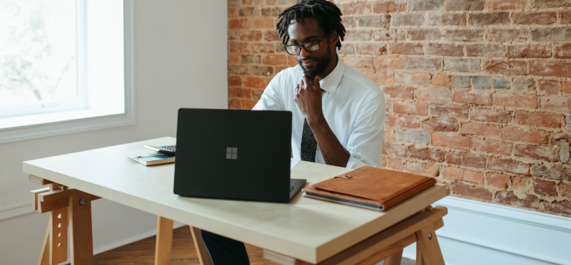 A person trying setting up the business using a Microsoft laptop.